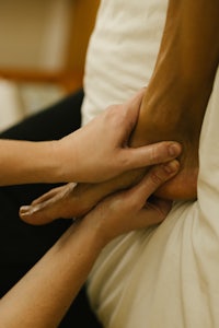 a person getting a foot massage on a bed