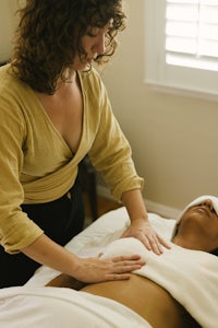 a woman giving a massage to a woman